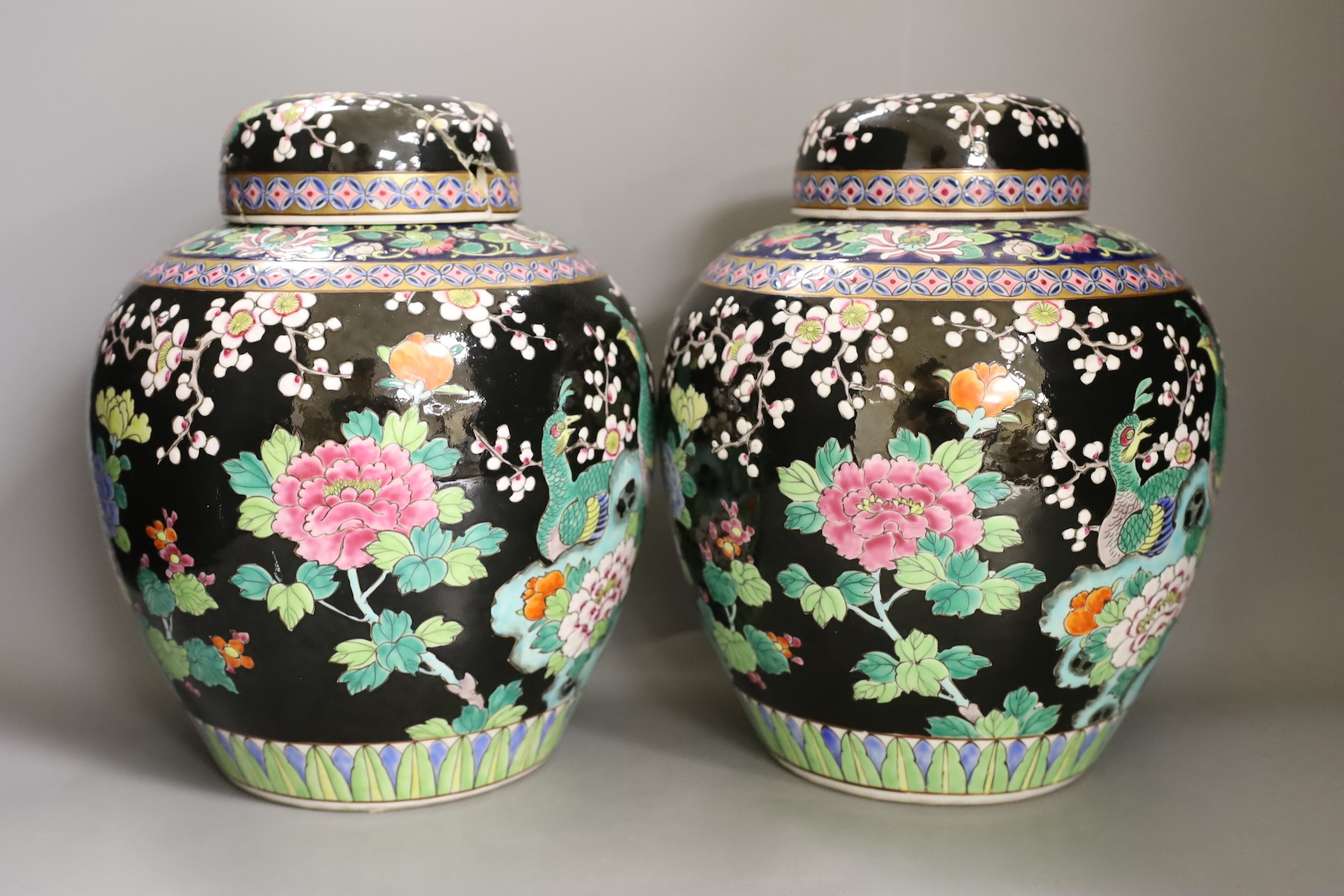 A pair of Japanese famille noire jars and covers, early 20th century, 27cm